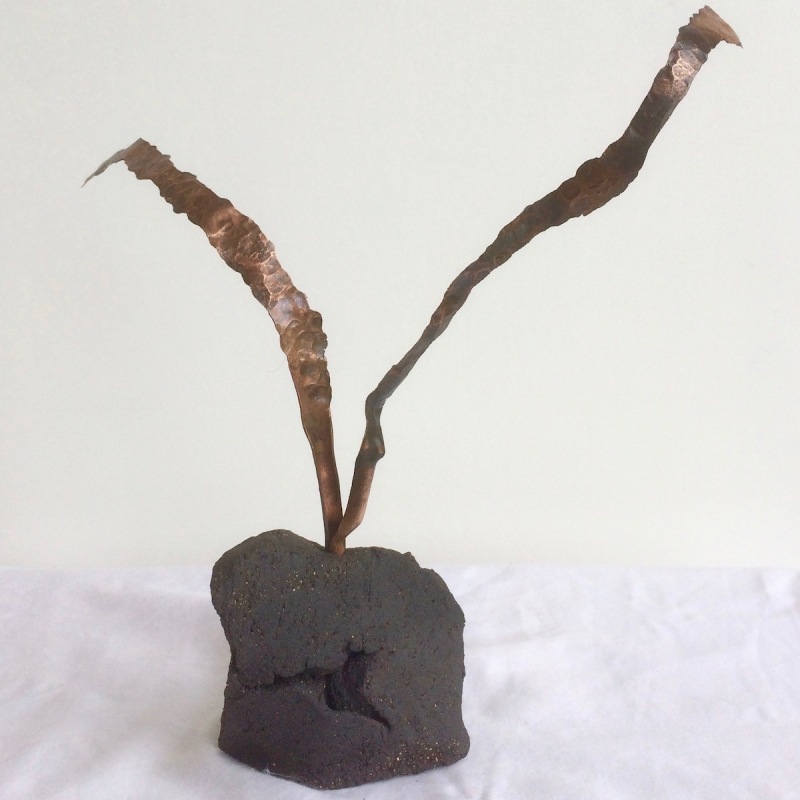 Twin sprouts a small sculpture of 2 copper ribbons emerging from black stoneware base.